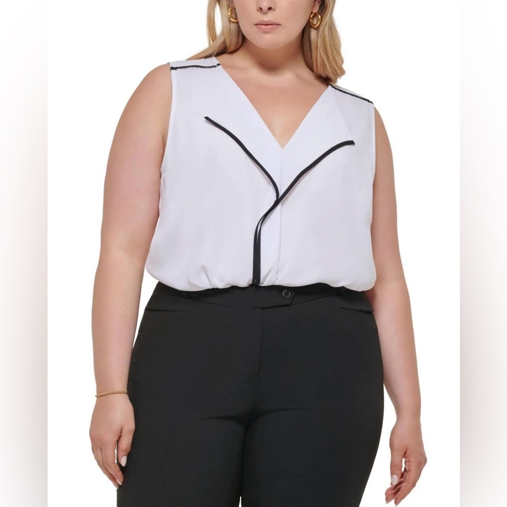Calvin Klein white sleeveless blouse with black trim details. Size large. NWT
